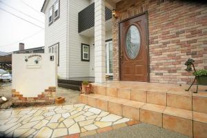 アイアンの表札がカワイイですね。柵などで庭を囲っていないので広々とオープンなエクステリアになりました。